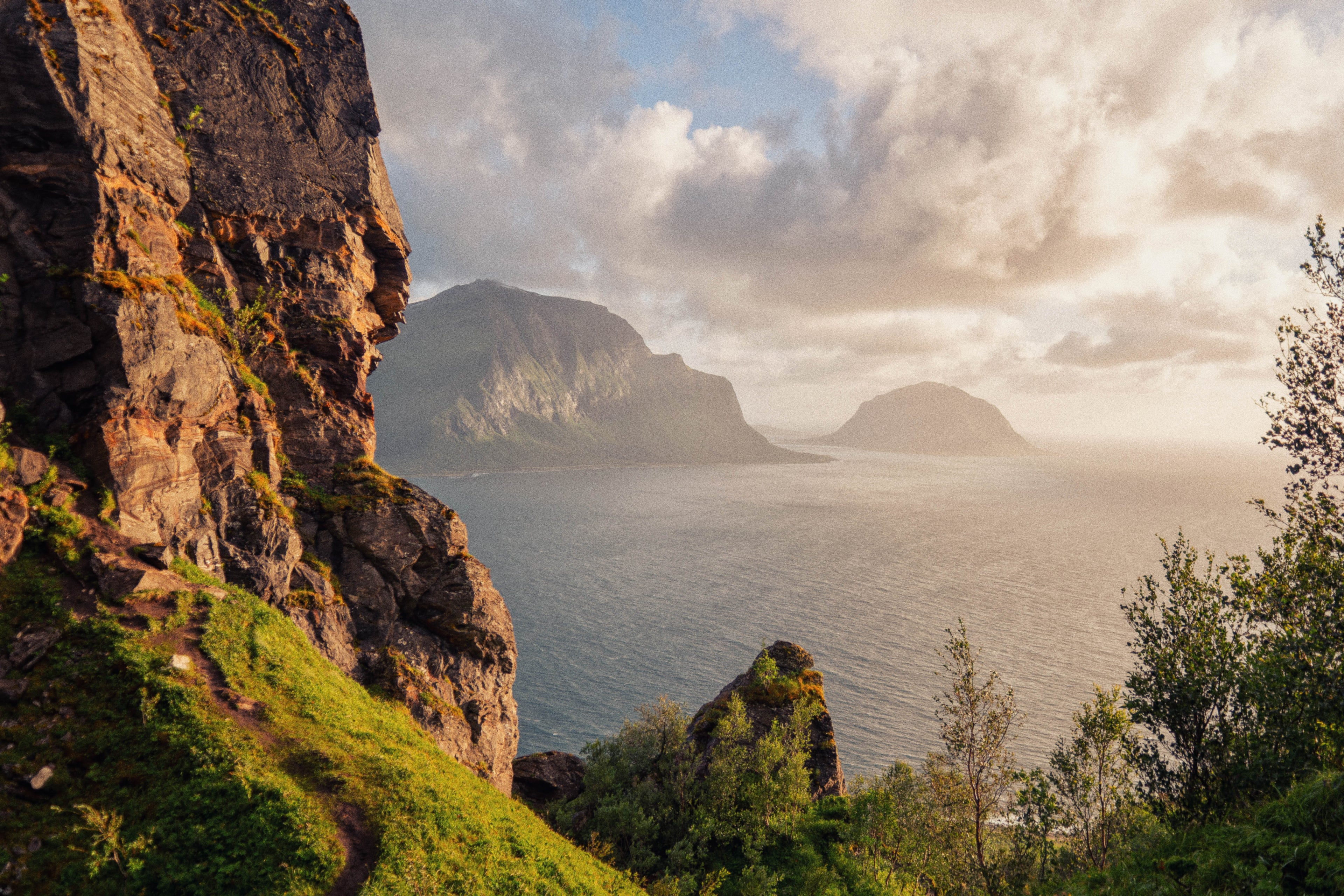 Scenic view of a fjord with rocky cliffs and greenery